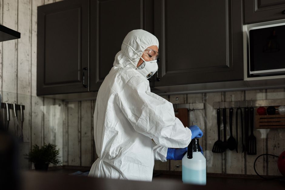 A person cleaning a 3D printer enclosure with a microfiber cloth