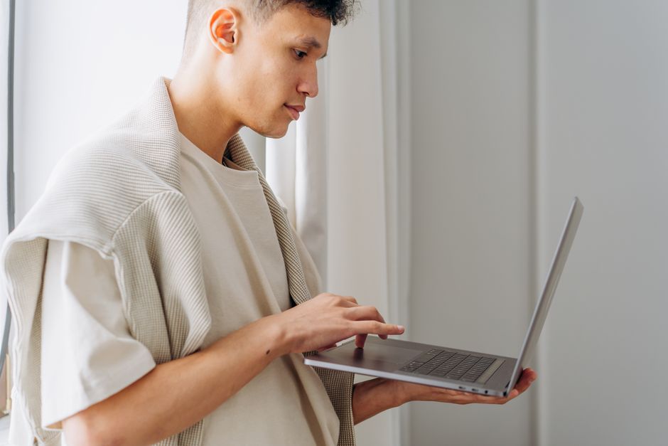 Why Is My Printer Printing Blank Pages? 8 Easy Ways to Fix It 1 A user looking frustrated at a printer ejecting blank sheets of white paper